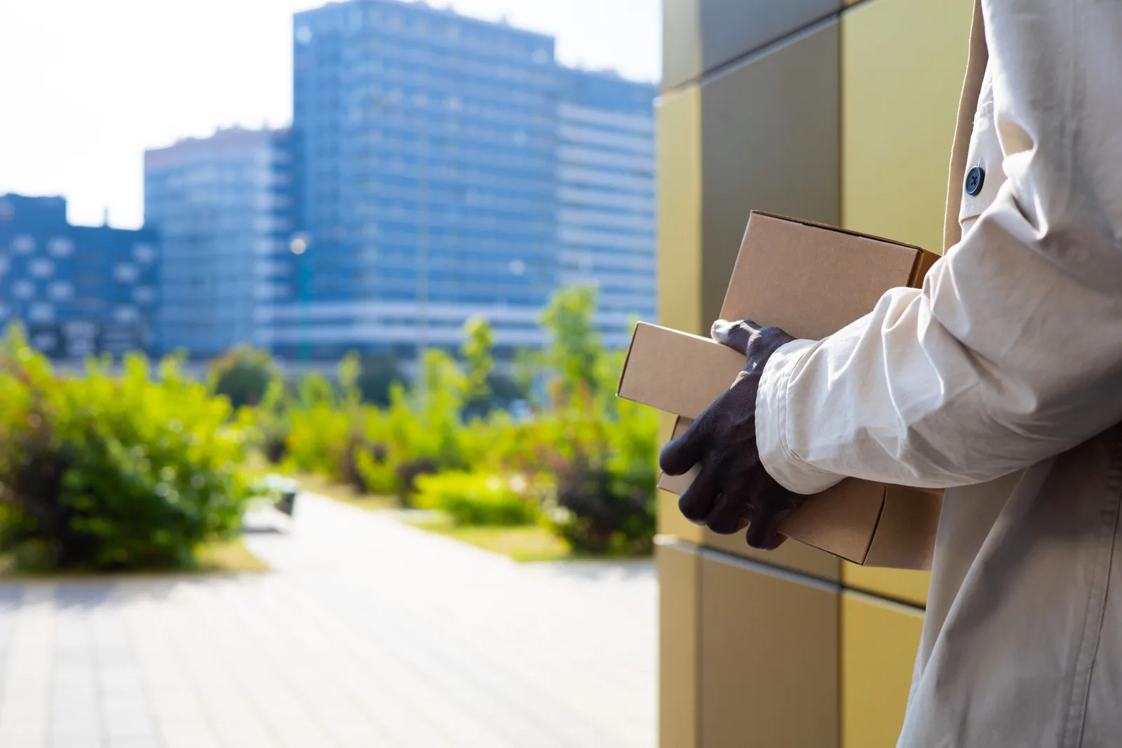 Several secure package delivery boxes compared side by side for a porch
