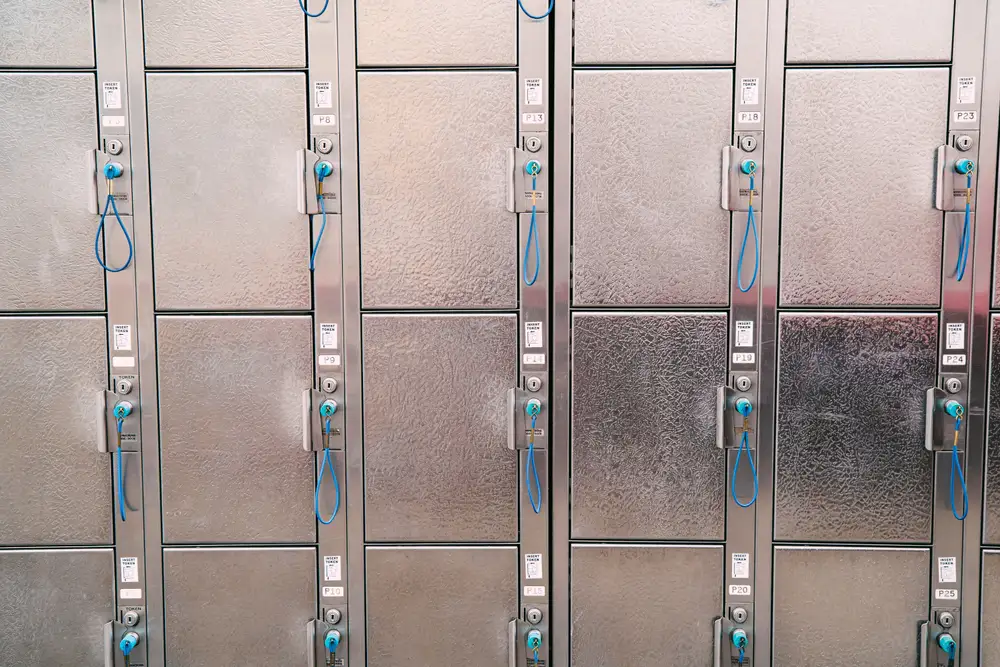 Numbered lockable racks slots holding individual lock boxes inside a building entrance