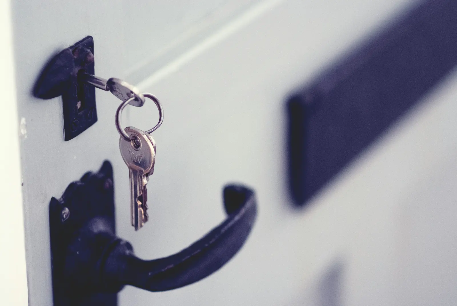 Property manager reviewing a property management lockbox access log at a building front desk